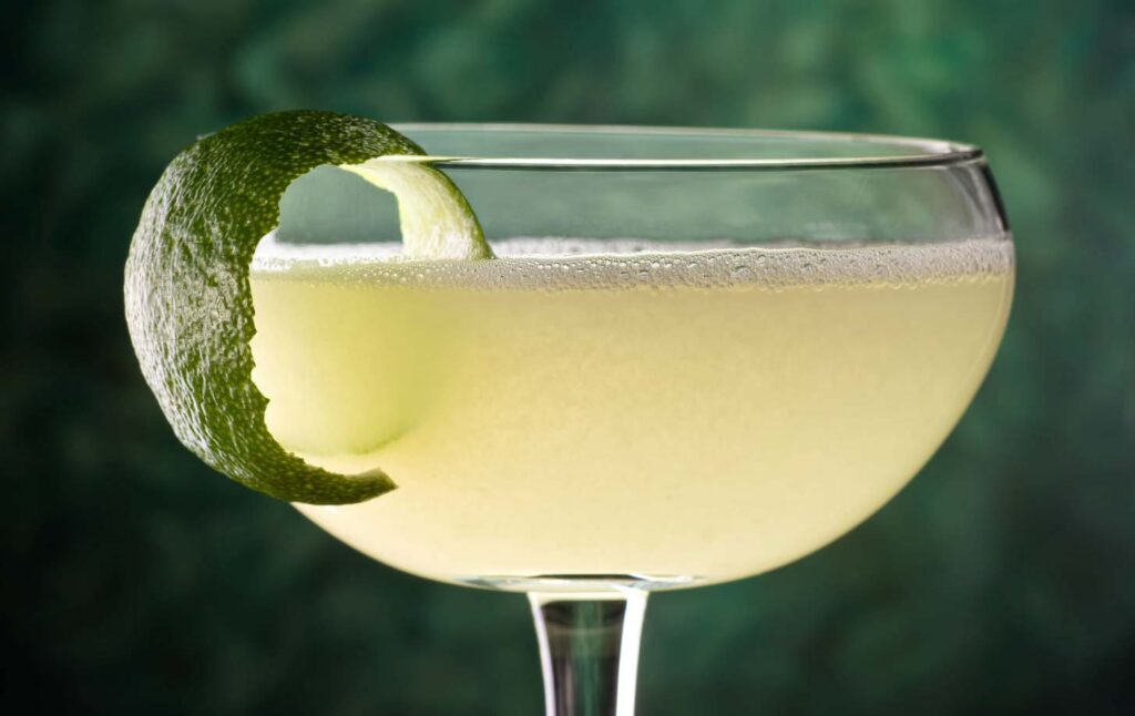 Ein Daiquiri-Cocktail mit einer Limettenzeste. Quelle: Fotolia.com © fudio